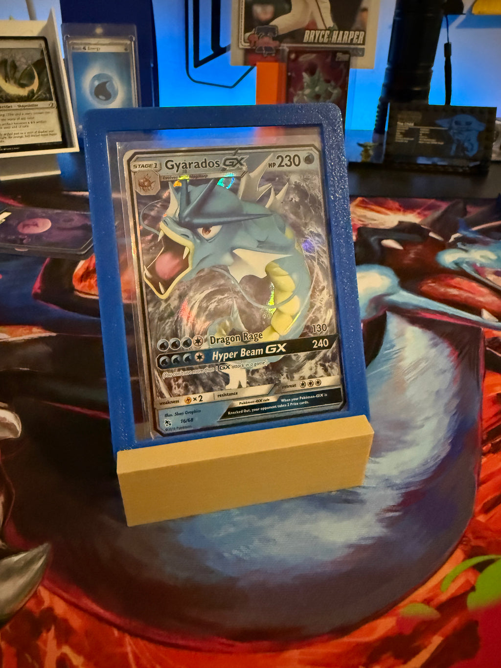Pokémon trading card featuring Gyarados GX on a display stand with a colorful background.